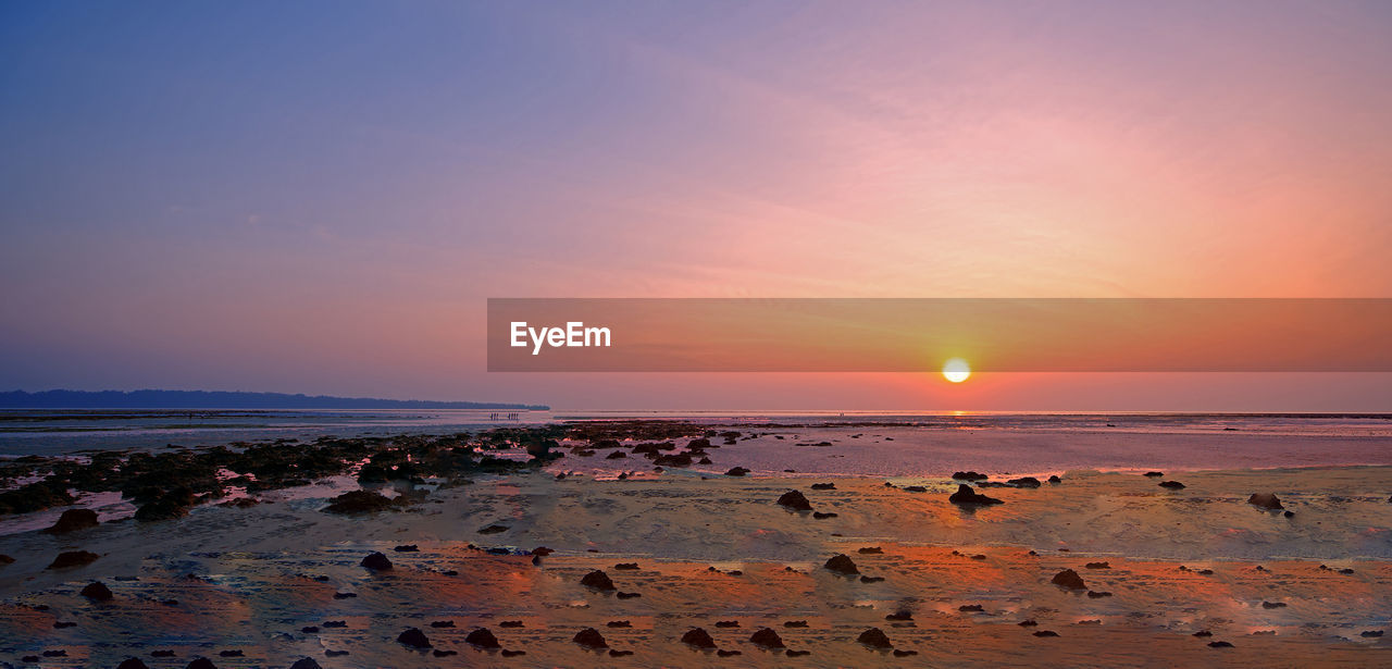 SCENIC VIEW OF BEACH DURING SUNSET