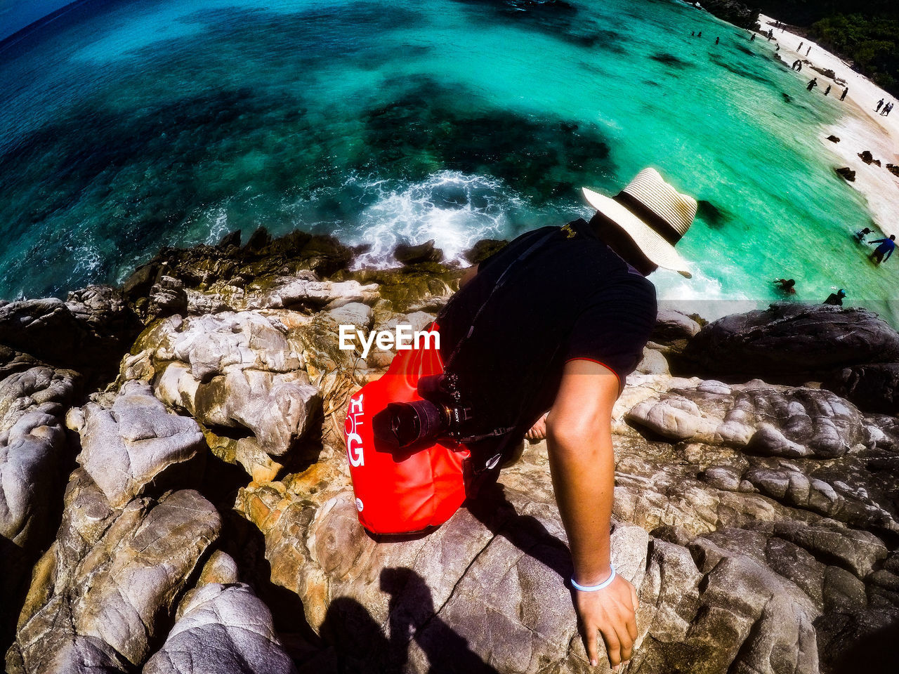 HIGH ANGLE VIEW OF MAN STANDING ON ROCK