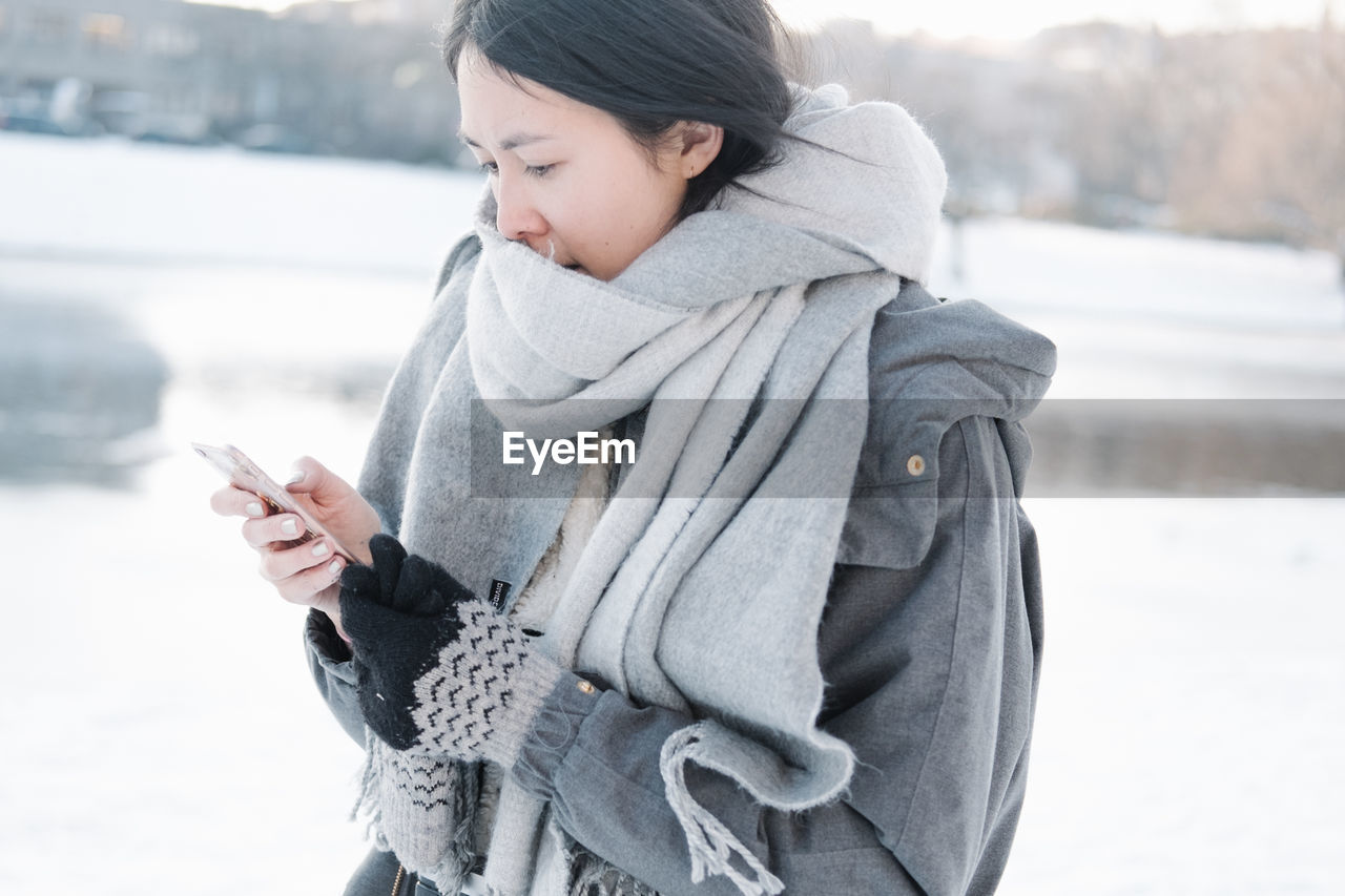 Woman in snow covered city