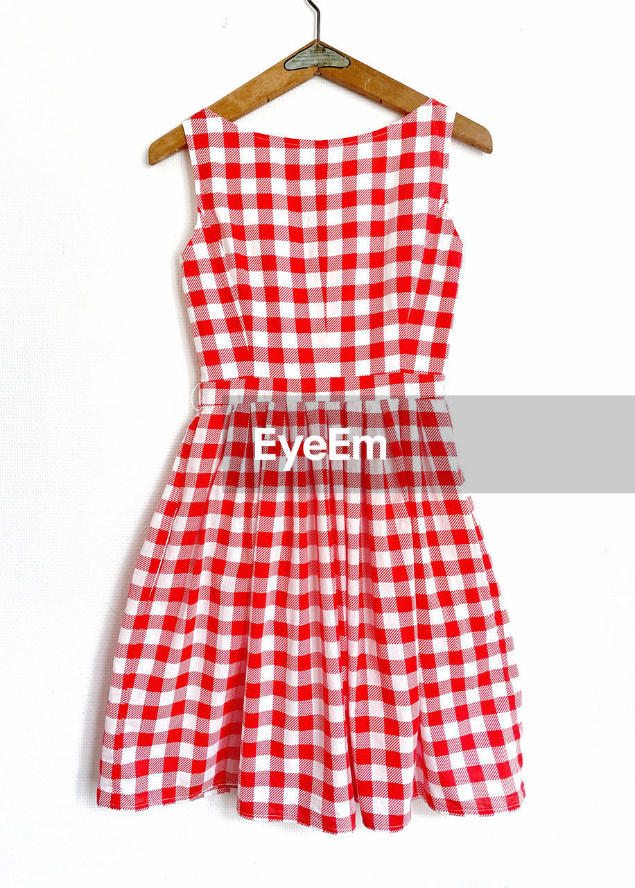 pattern, white background, fashion, red, checked pattern, clothing, sleeve, coathanger, cut out, white, hanging, studio shot, pink, indoors, dress, plaid, no people, textile, tartan, maroon, orange, day dress, cotton, single object, polka dot
