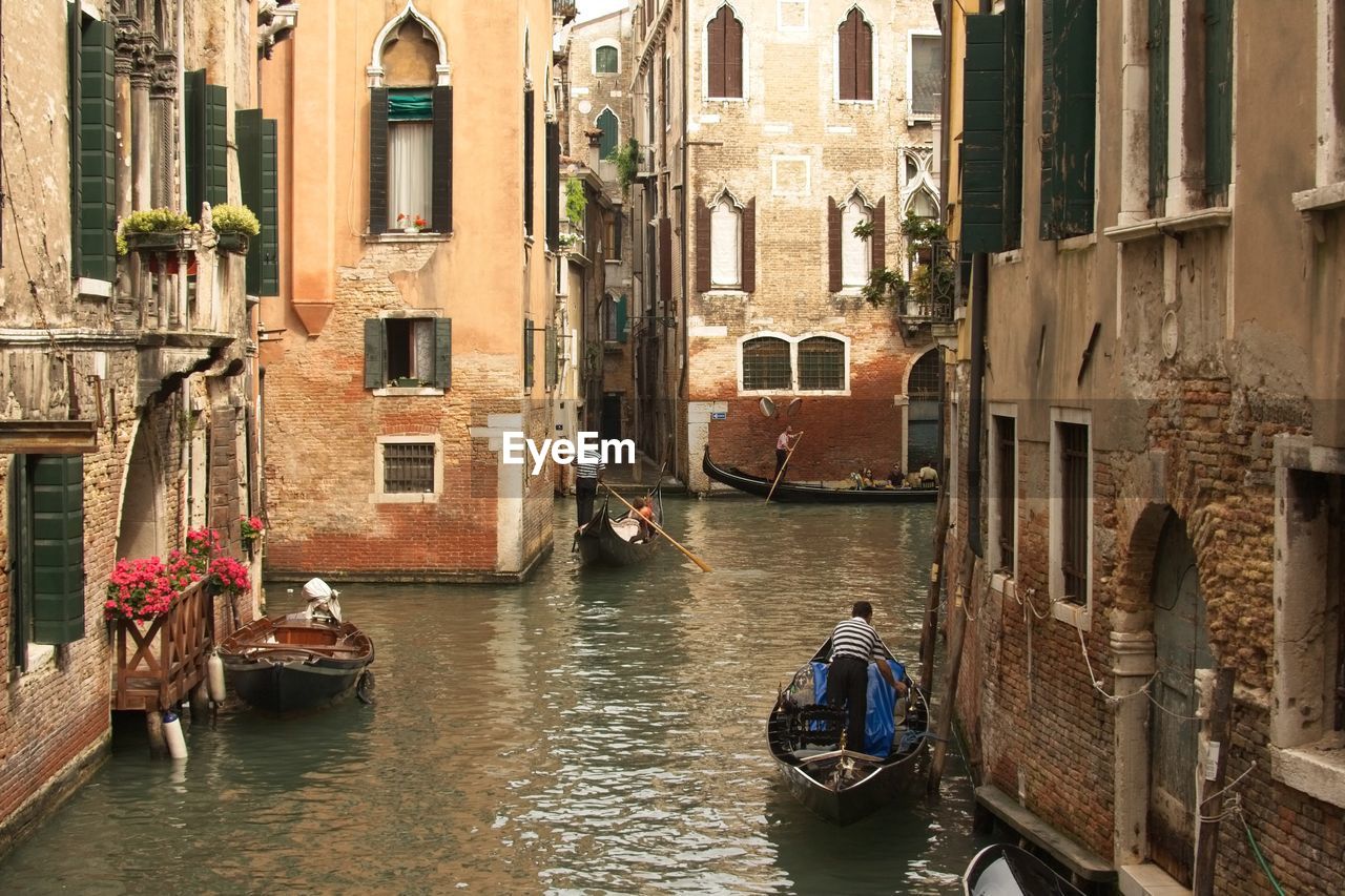 Canal amidst buildings in city. venice. italy 