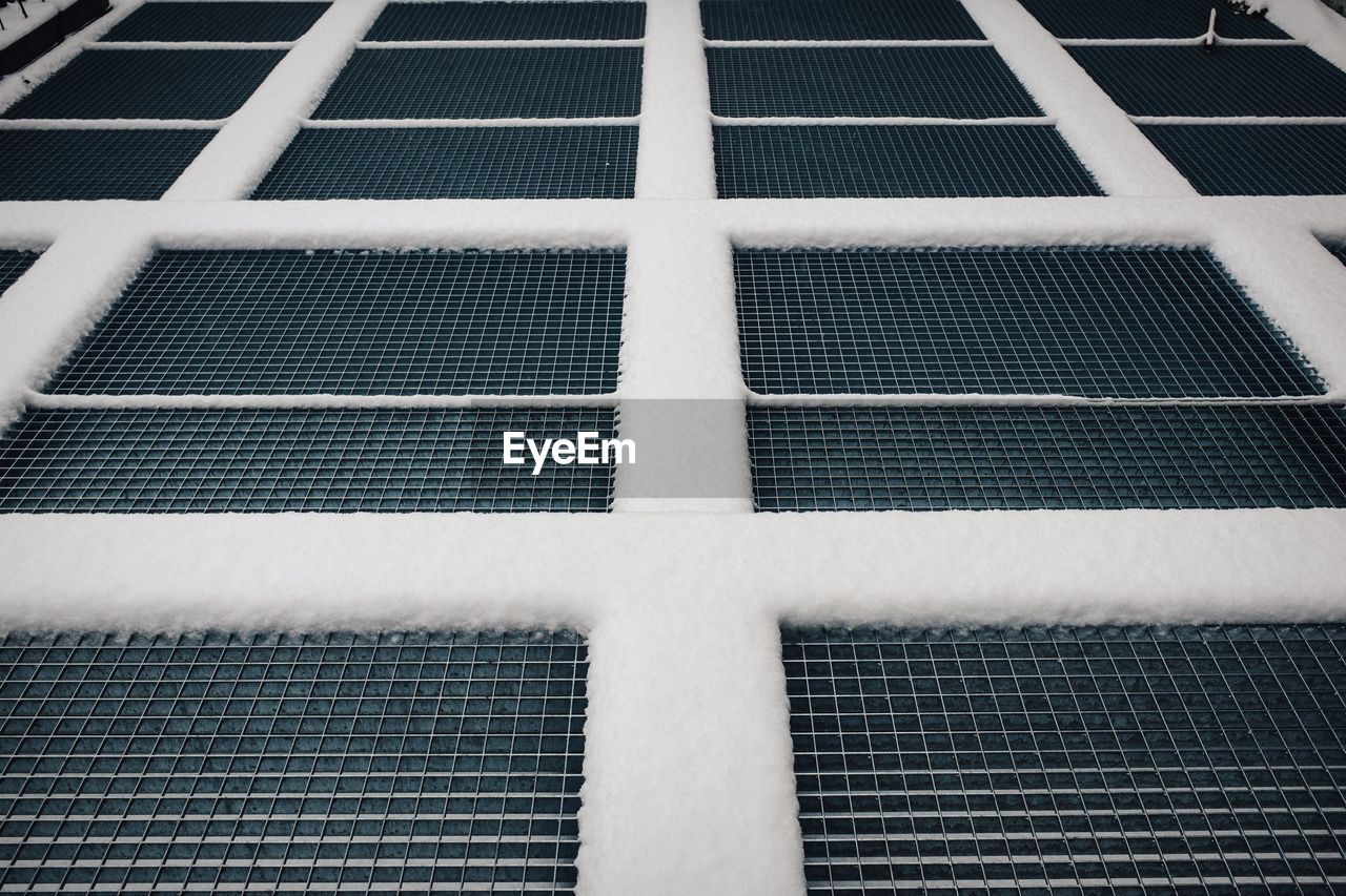 Full frame shot of snow on metal grate