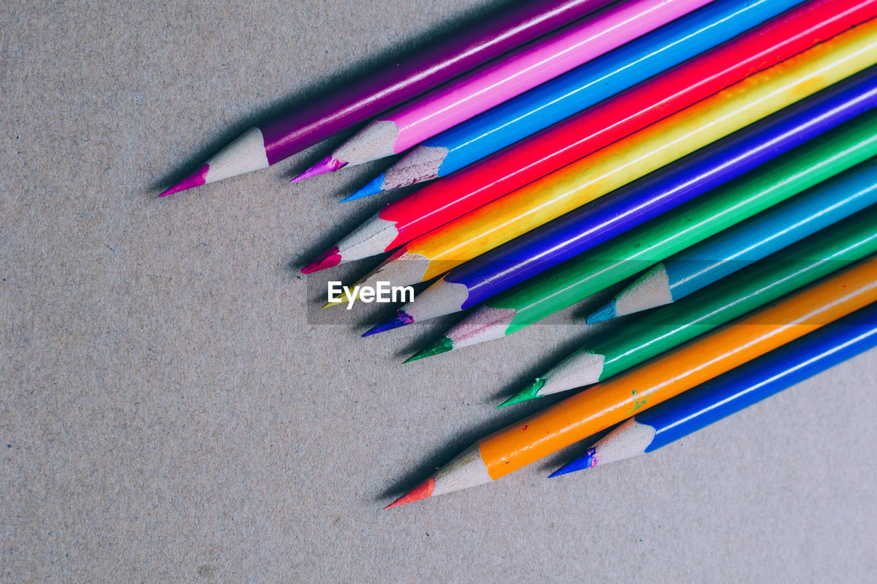 Close-up of colored pencils on green table