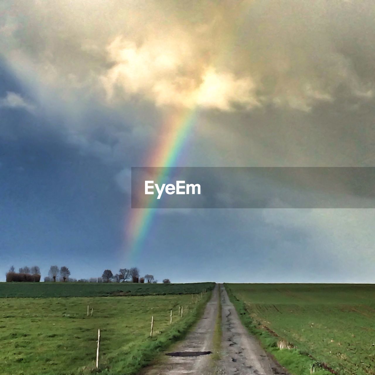 Dirt road and beautiful rainbow