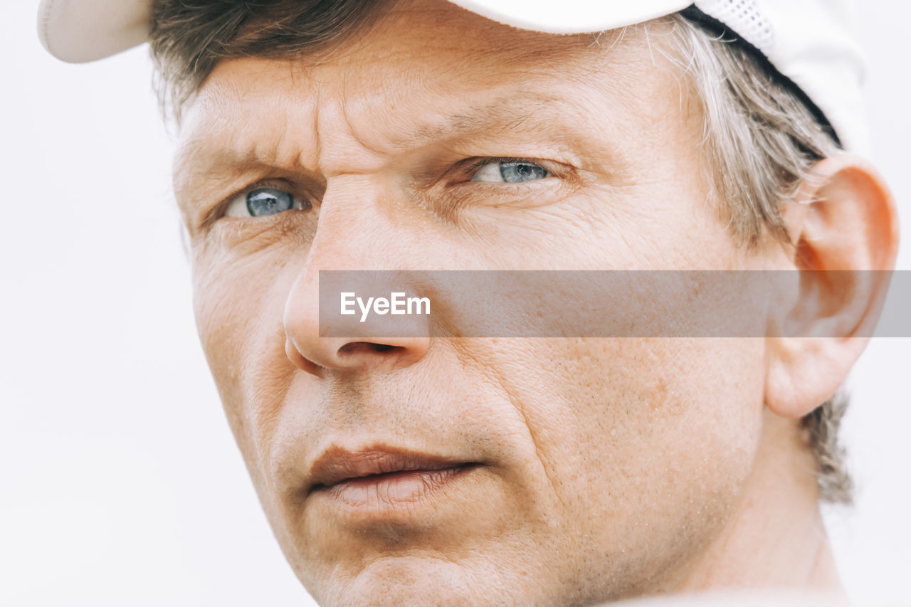 Close-up portrait of man against white background