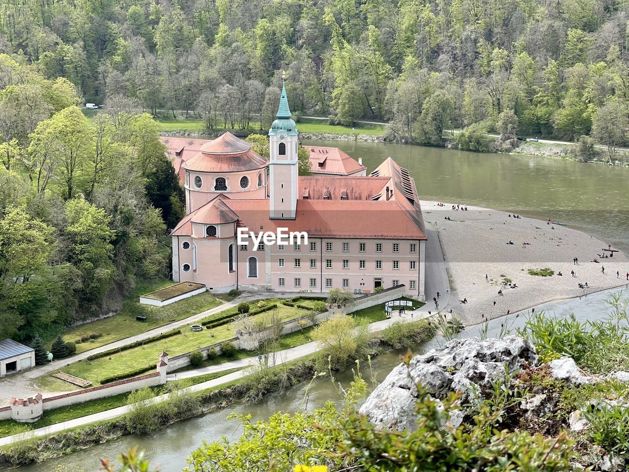 High angle view of building by lake against trees