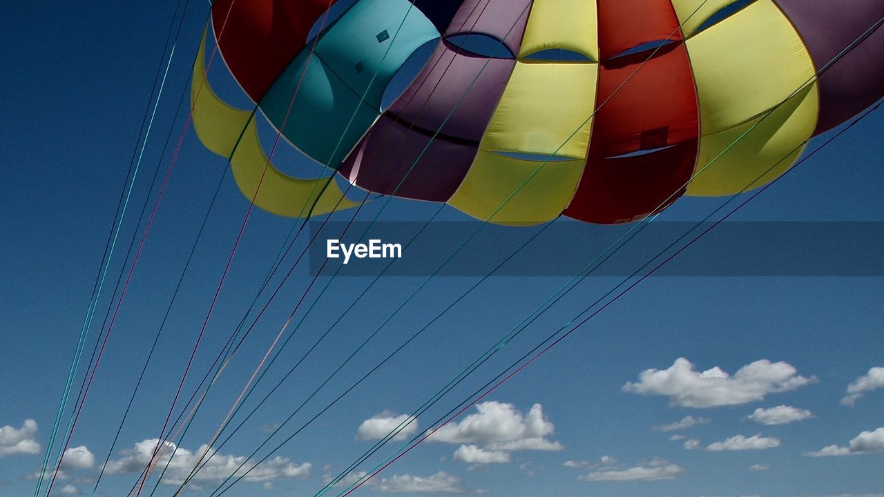 Low angle view of parachute against sky