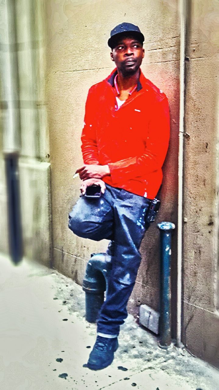 FULL LENGTH PORTRAIT OF YOUNG MAN STANDING ON ROAD