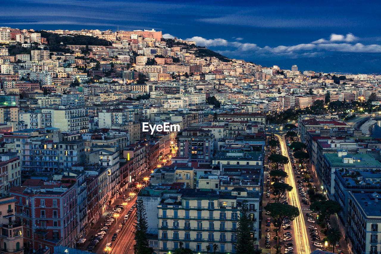 High angle view of illuminated city buildings against sky