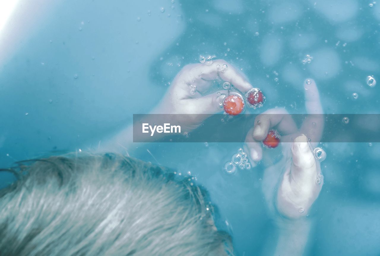 High angle view of child in swimming pool