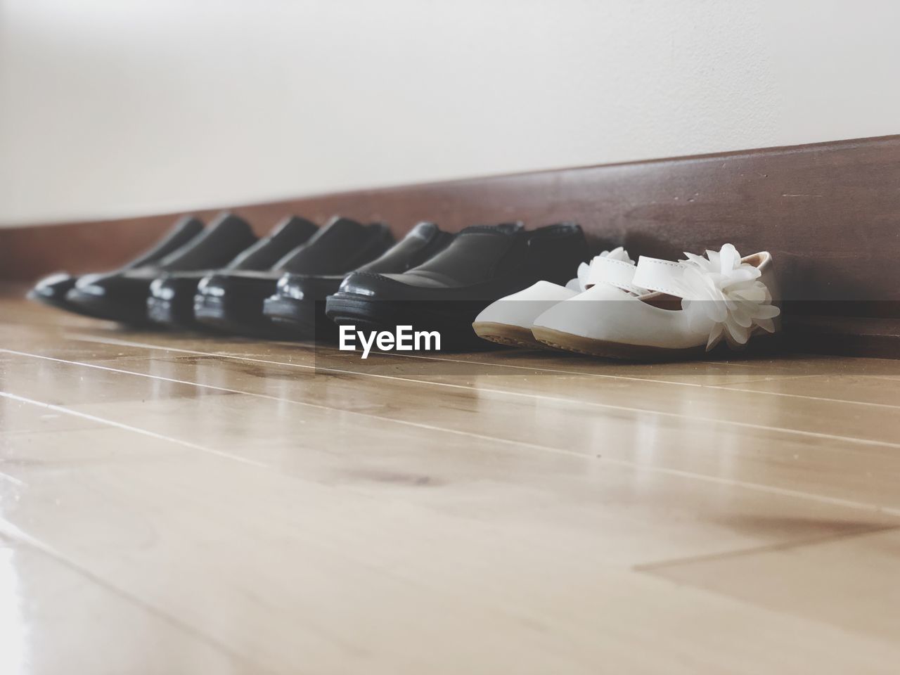 CLOSE-UP OF WHITE SHOES ON TABLE