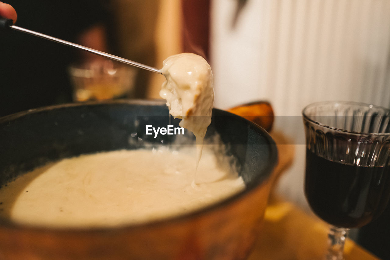 Close-up of cheese fondue in bowl on table