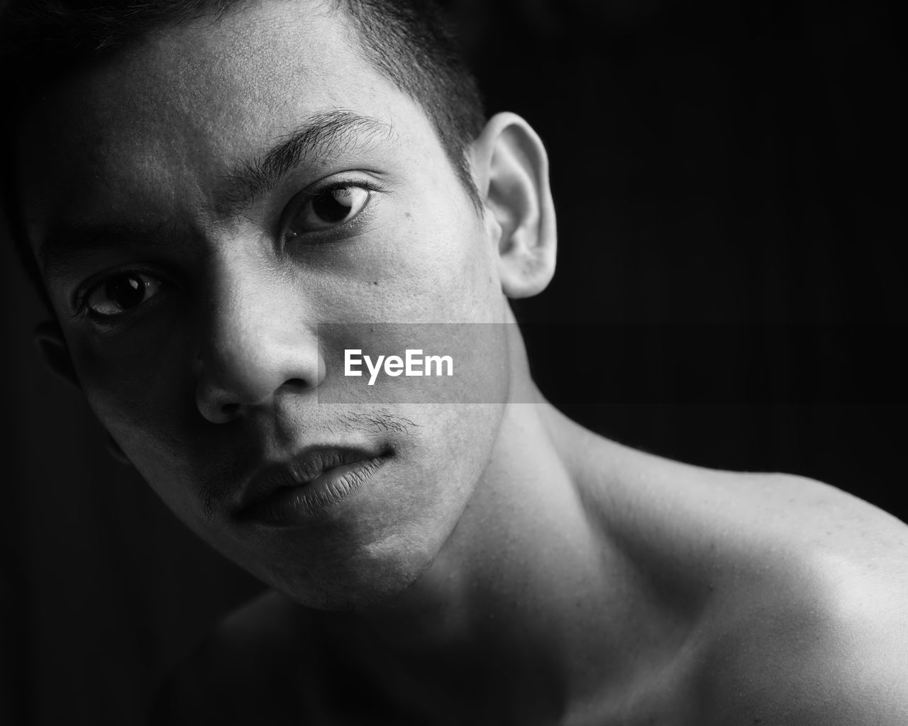 Close-up portrait of shirtless man