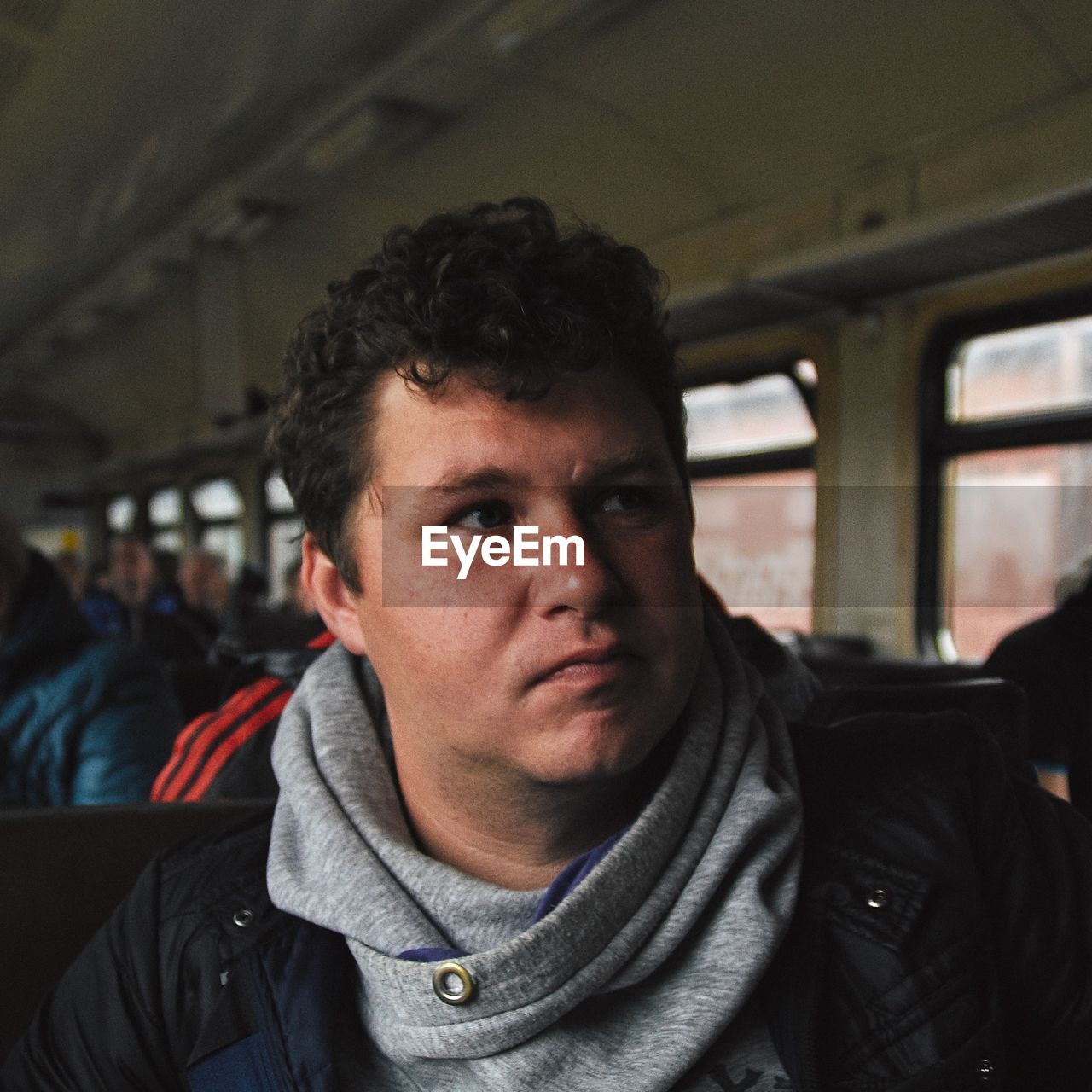 Man looking away in train