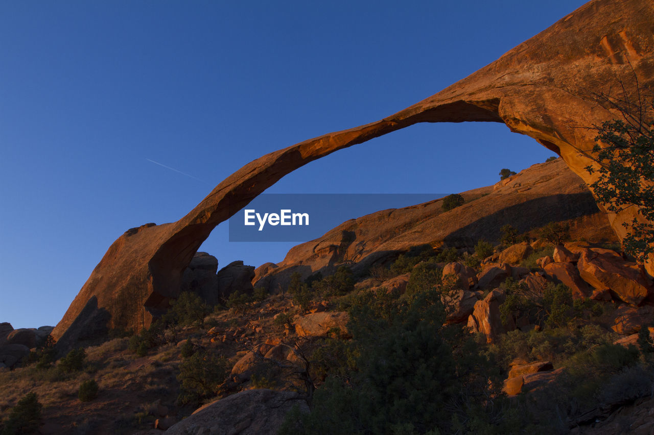 Low angle view of rock formation against sky