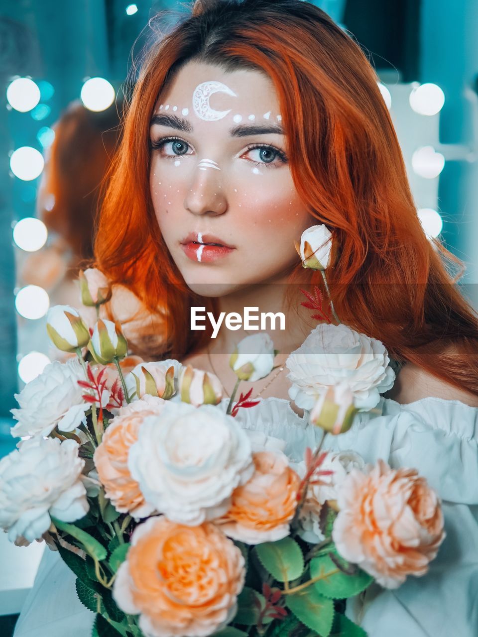 CLOSE-UP PORTRAIT OF A BEAUTIFUL YOUNG WOMAN WITH RED FLOWER