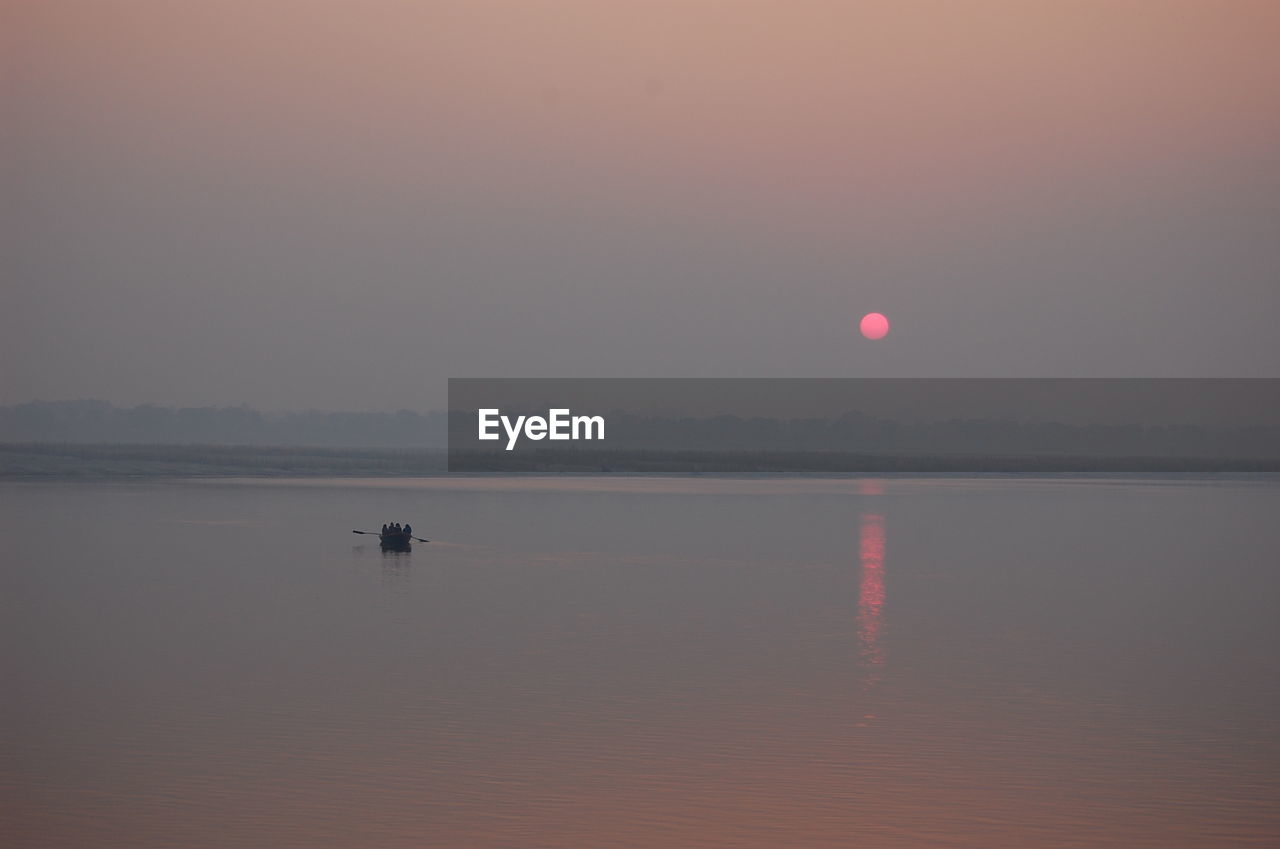 Scenic view of sea against sky at sunset