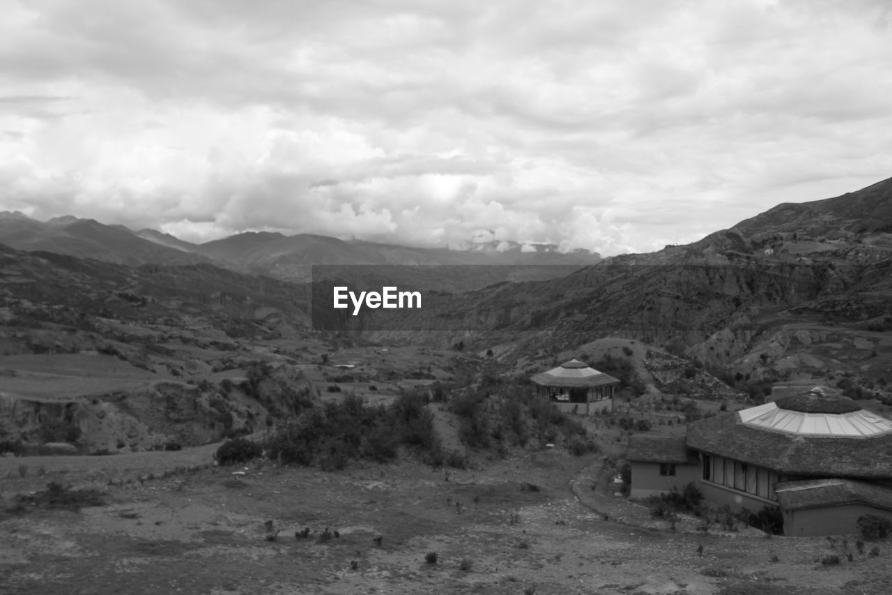 SCENIC VIEW OF MOUNTAINS AGAINST CLOUDY SKY