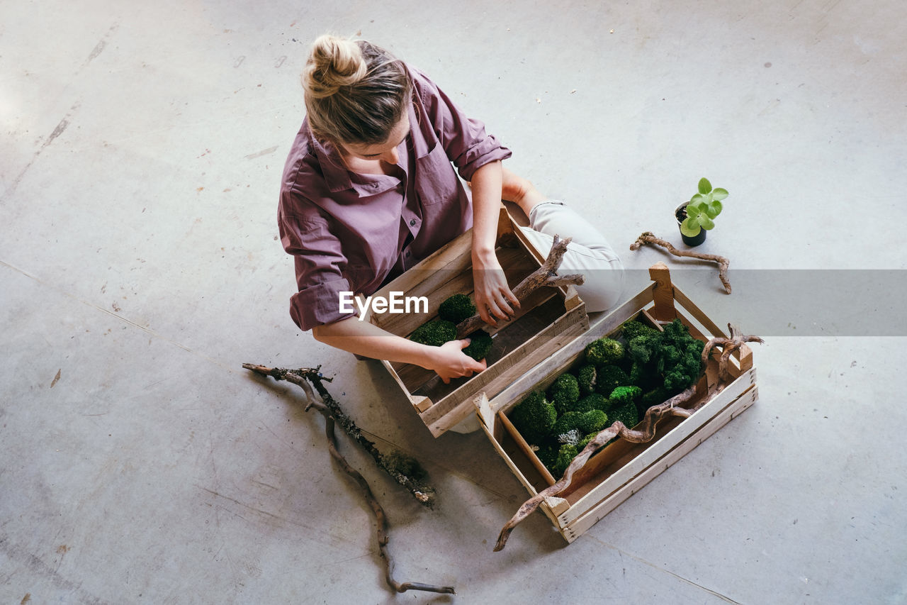 HIGH ANGLE VIEW OF WOMAN WORKING WITH FOOD