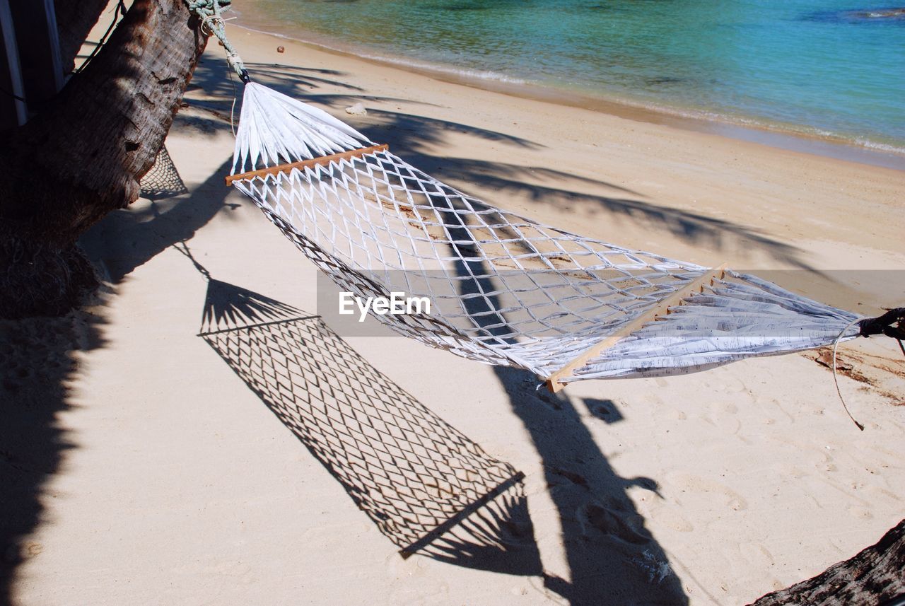 Hammock hanging at beach during sunny day