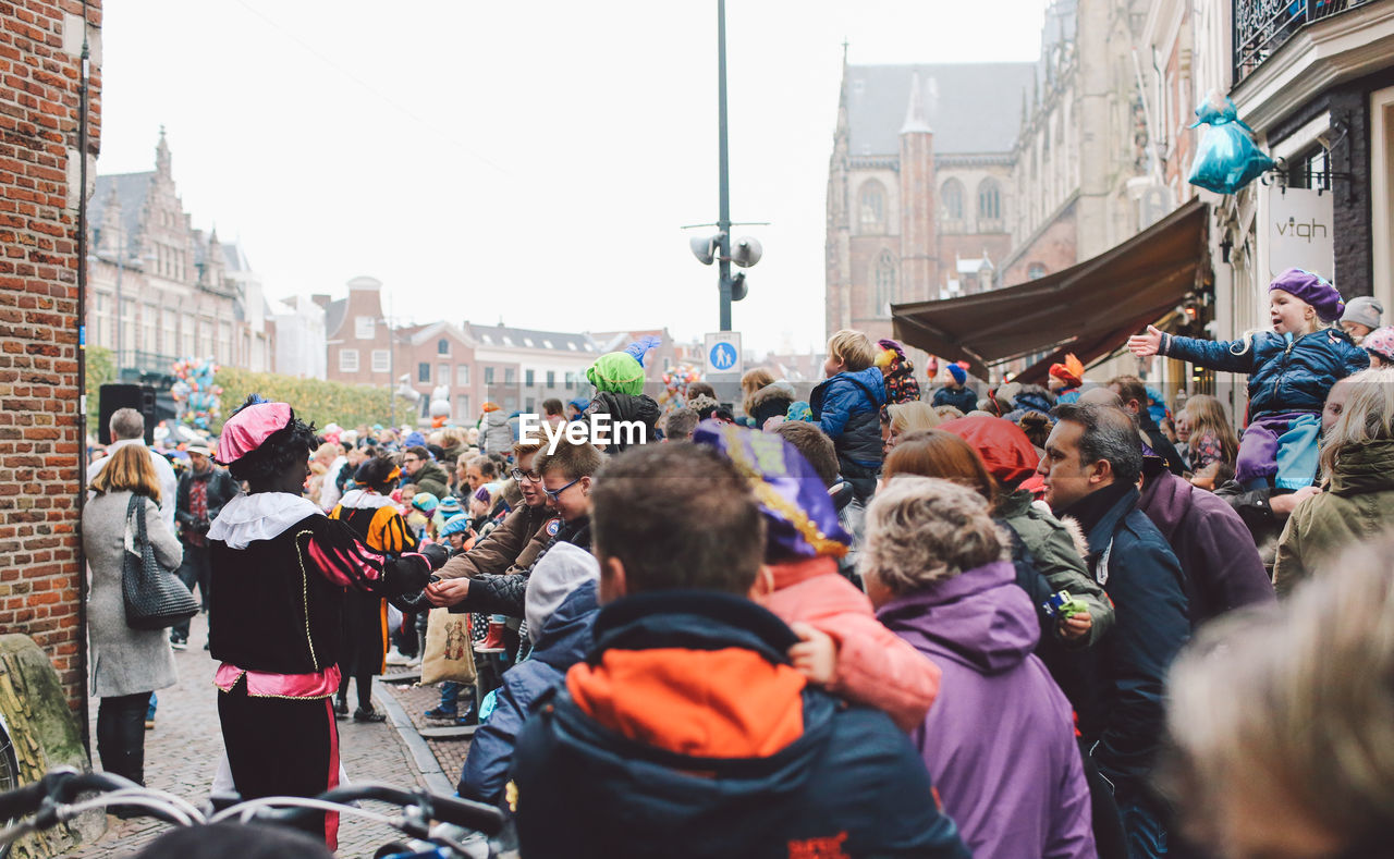 CROWD OF PEOPLE IN CITY