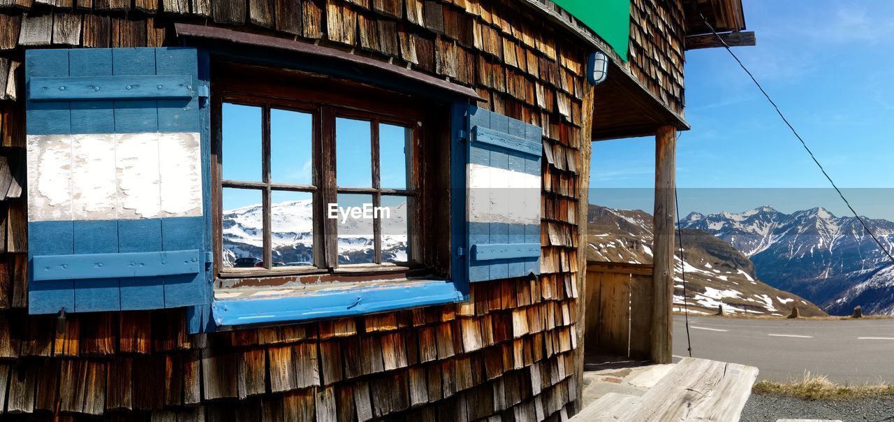 Built structure on snow covered mountains against sky
