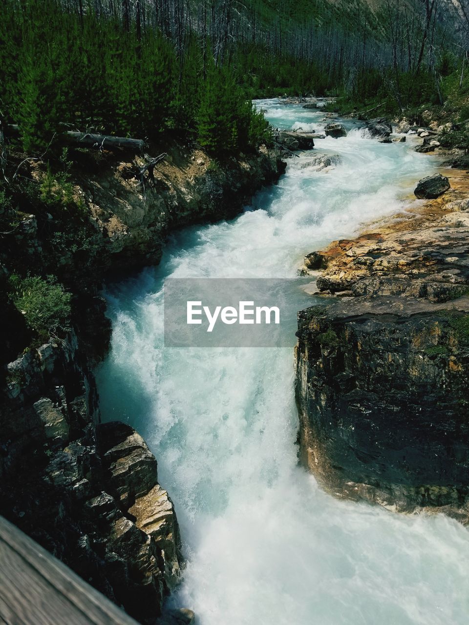 HIGH ANGLE VIEW OF WATERFALL IN RIVER