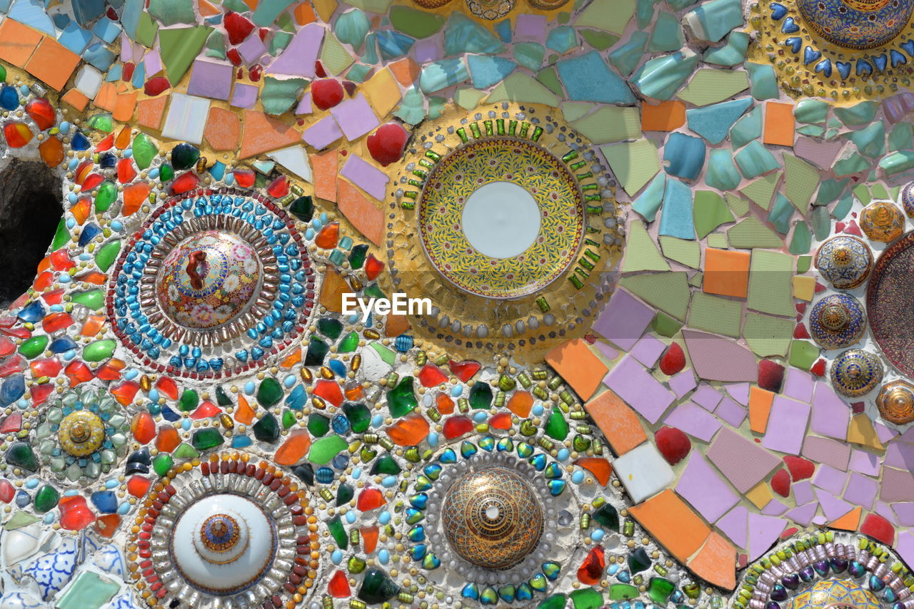 HIGH ANGLE VIEW OF MULTI COLORED UMBRELLAS ON TILED TABLE