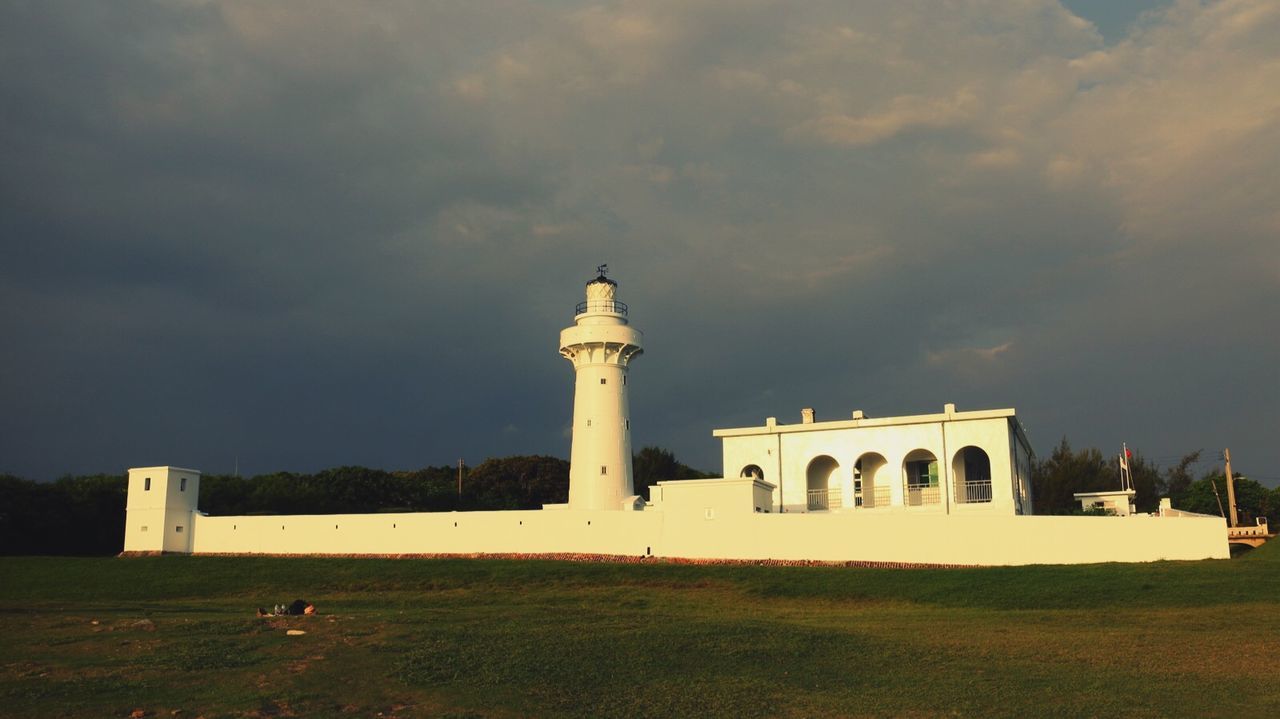 Built structure against sky with lawn in foreground