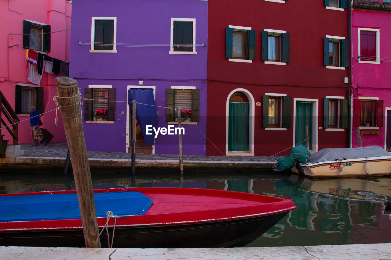 MULTI COLORED HOUSES AGAINST BUILDING