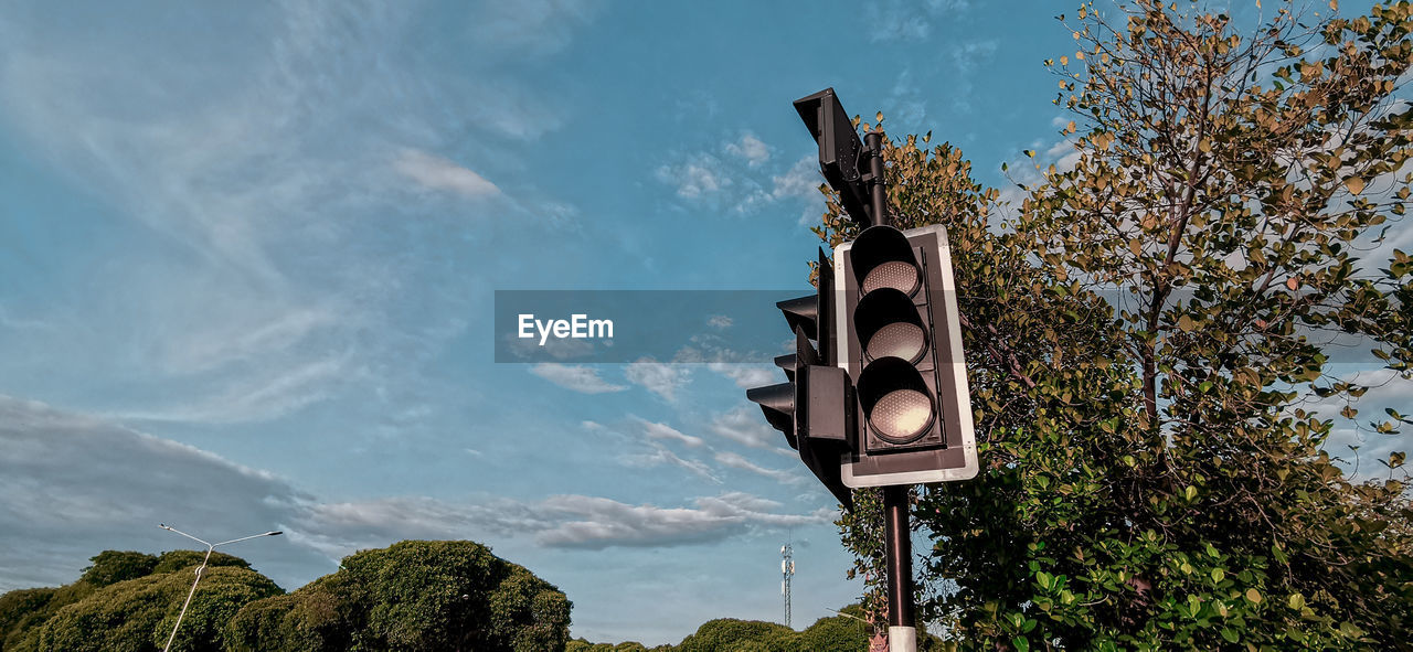 Low angle view of road sign against sky