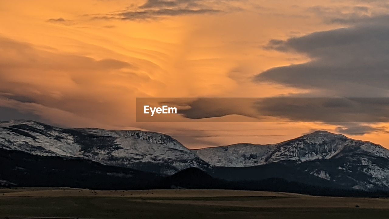 scenic view of snowcapped mountain against sky during sunset