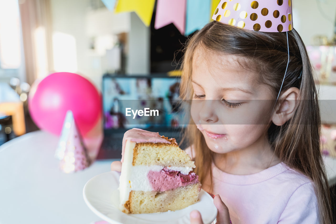 Cute girl holding cake in plate