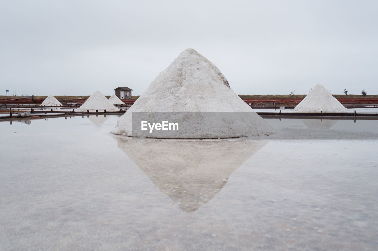 Jingzaijiao tile paved salt fields with dry salt ready for harvesting in cloudy weather in tainan city in taiwan