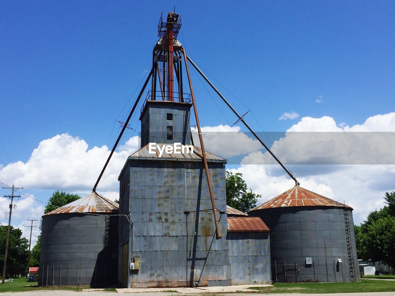 Low angle view of silos against sky