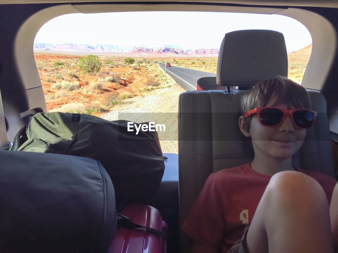 Boy on backseat during road trip