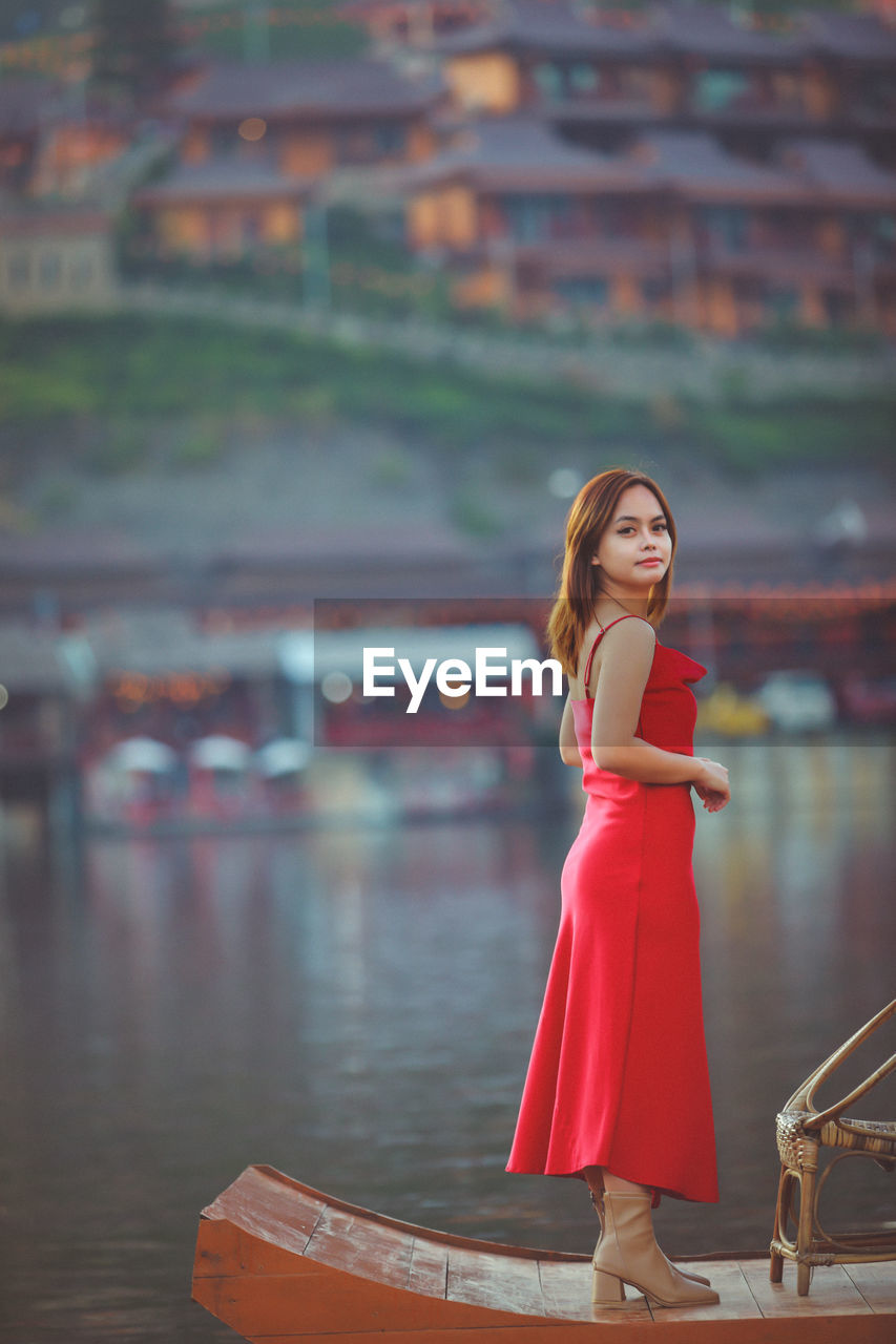 Asian woman wearing cheongsam traditional red dress on chinese new year travel.