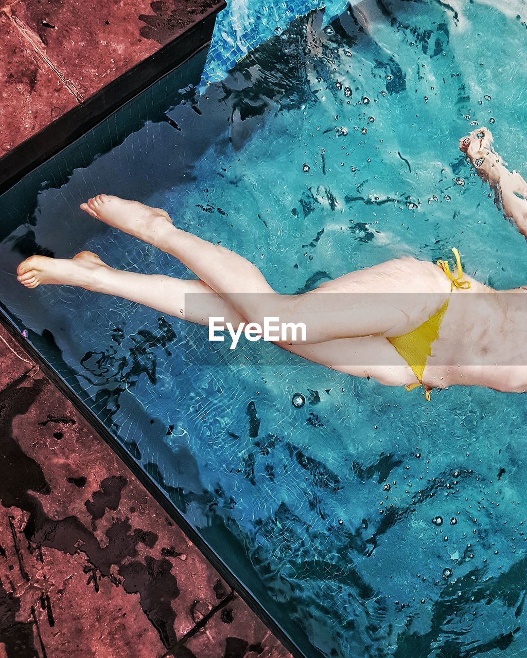 Low section of a woman in swimming pool