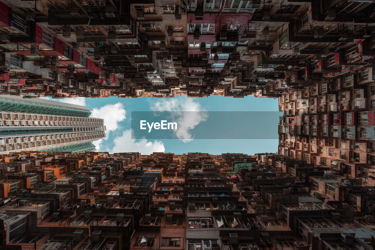 DIRECTLY BELOW SHOT OF BUILDINGS AGAINST SKY