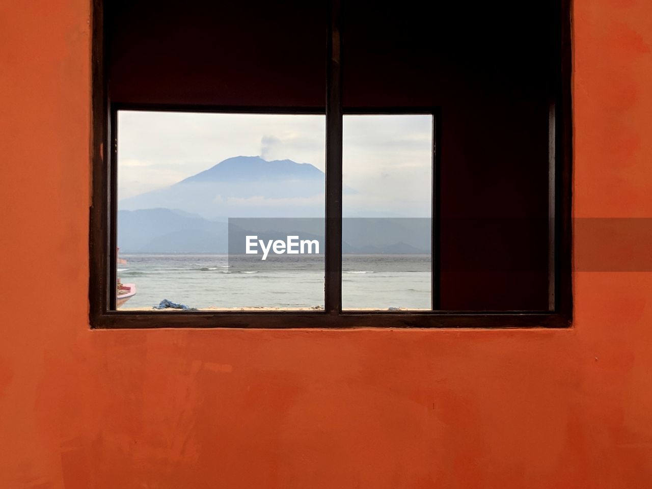 Mountain view  and sea seen through window