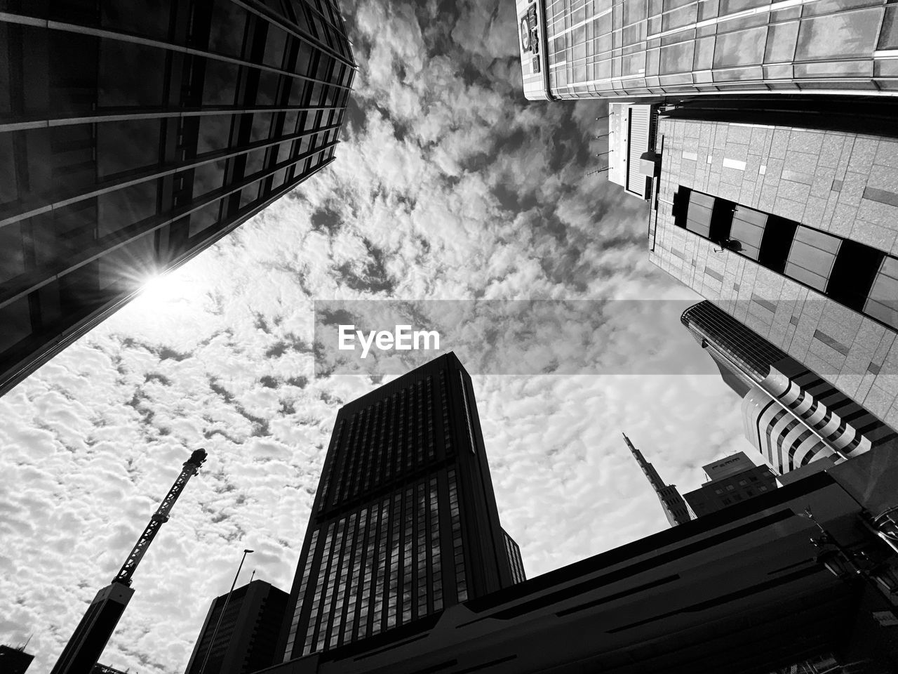 DIRECTLY BELOW SHOT OF MODERN BUILDINGS AGAINST SKY