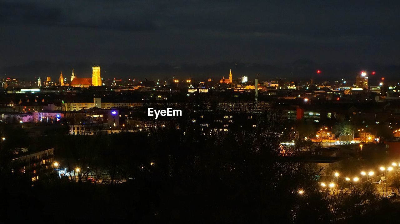 Illuminated buildings against the sky at night