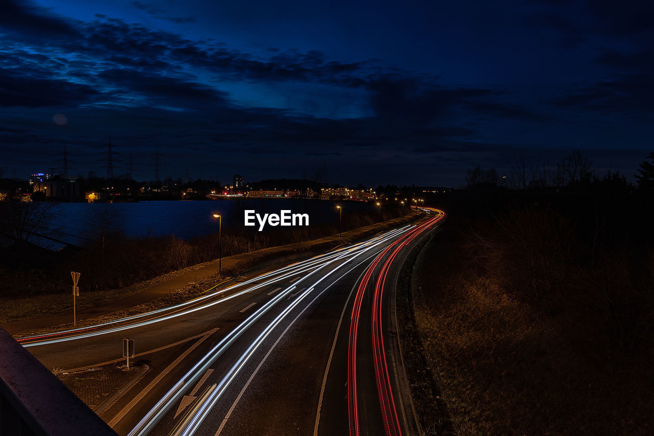 High angle view of light trails on highway at night