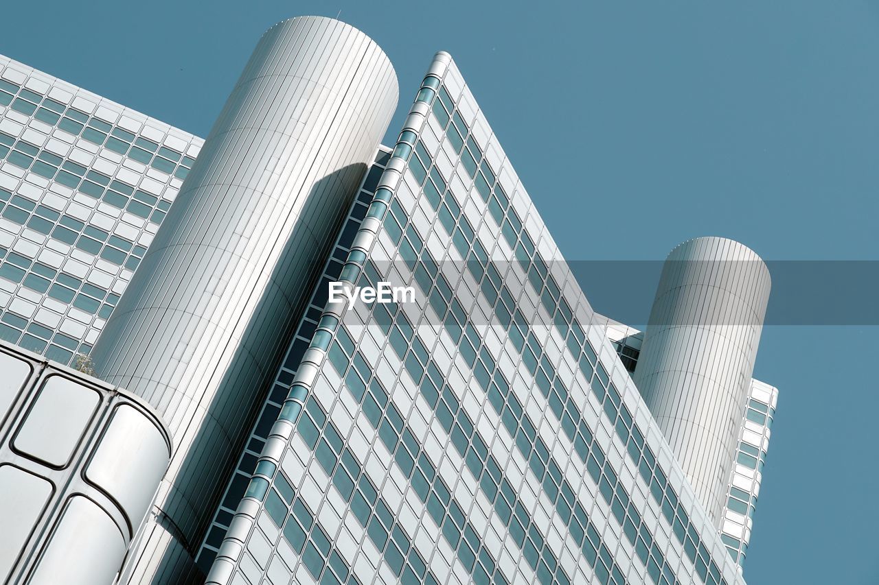 LOW ANGLE VIEW OF MODERN BUILDINGS AGAINST CLEAR SKY