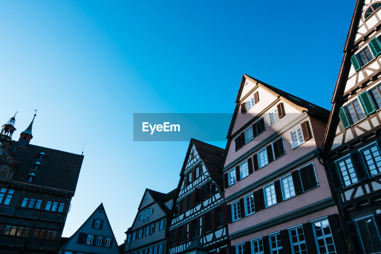 Low angle view of residential buildings against blue sky