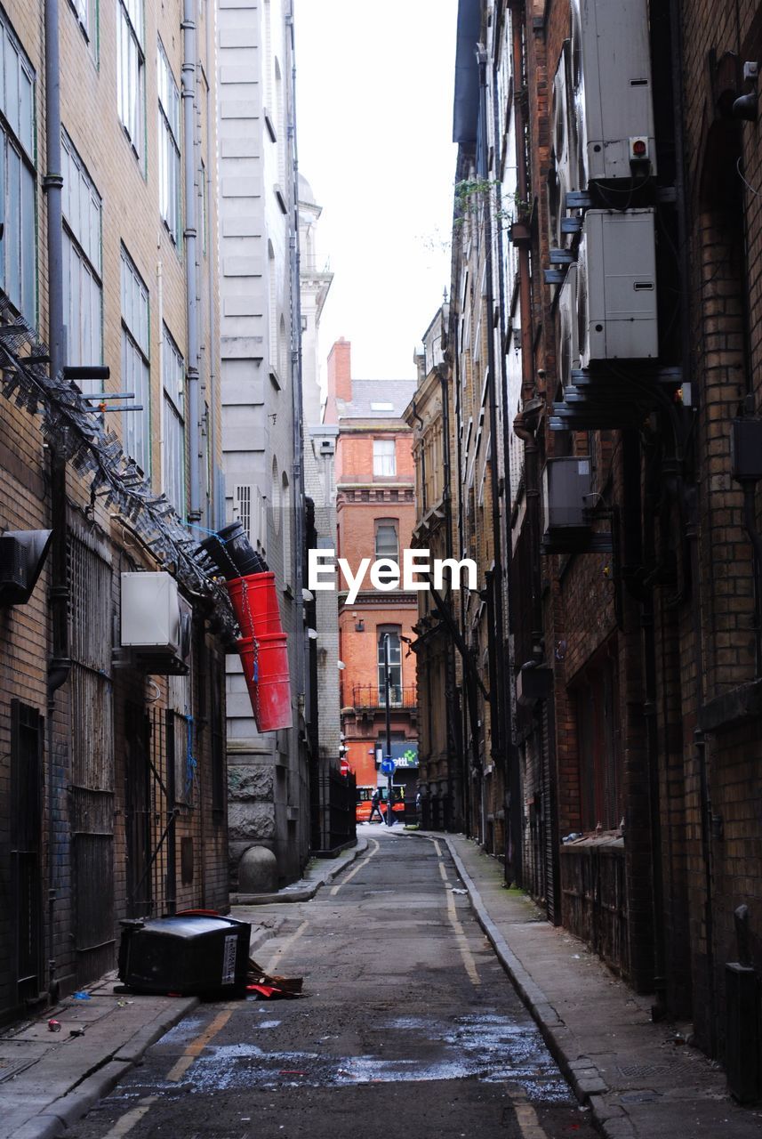 Narrow street amidst buildings in city