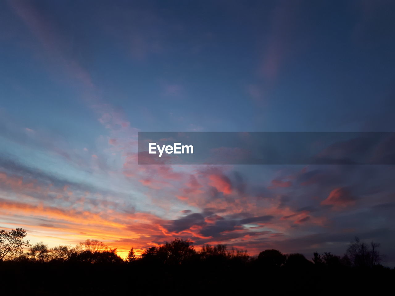 Silhouette landscape against sky during sunset