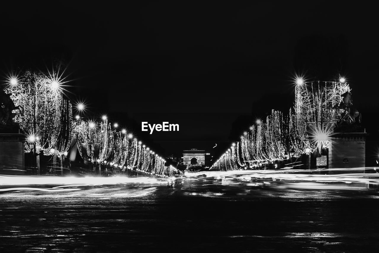 ILLUMINATED CITY STREET AT NIGHT