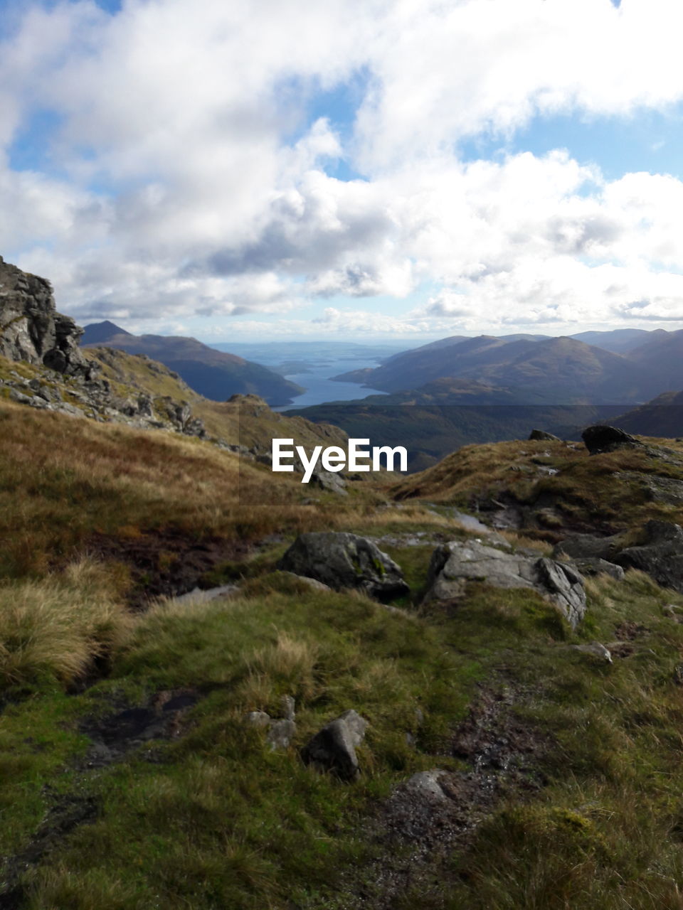 Scenic view of mountains against cloudy sky