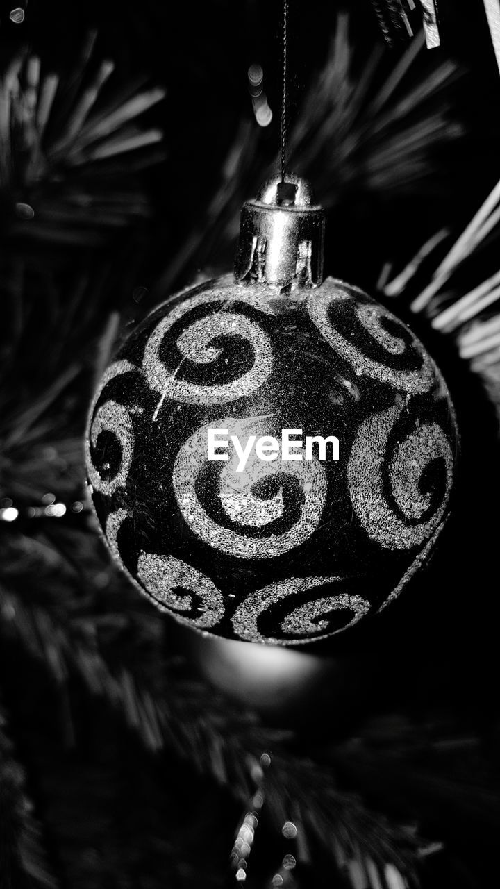 CLOSE-UP OF CHRISTMAS DECORATIONS HANGING ON WALL